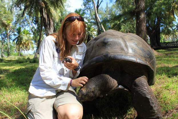 Kat Machin pictured with Desroches Island's youngest and oldest giant tortoises (photo: Kat Machin)