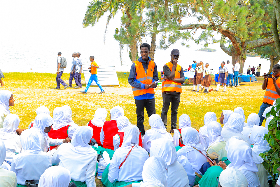 Julius Kirumira educating a group of young people about environmental conservation and animal welfare.