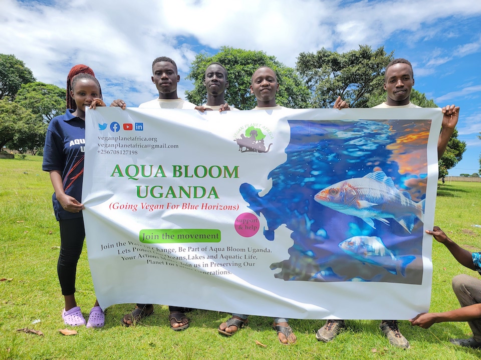 Members of the Aqua Bloom Uganda Project proudly holding up their banner, symbolising their commitment to marine conservation and environmental awareness in Uganda.