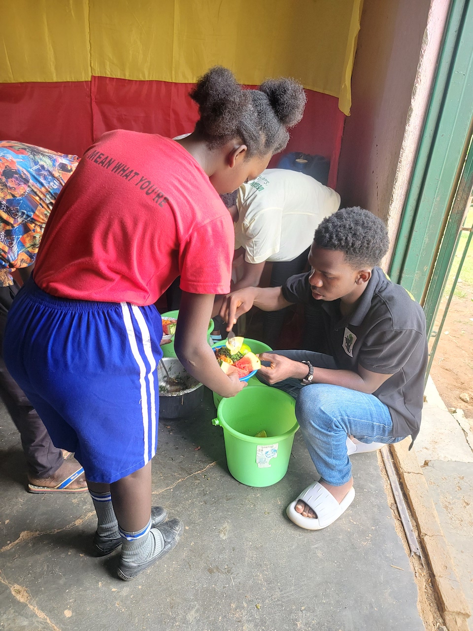 Julius serving vegan food at a local primary school as part of an educational drive to promote plant-based living.