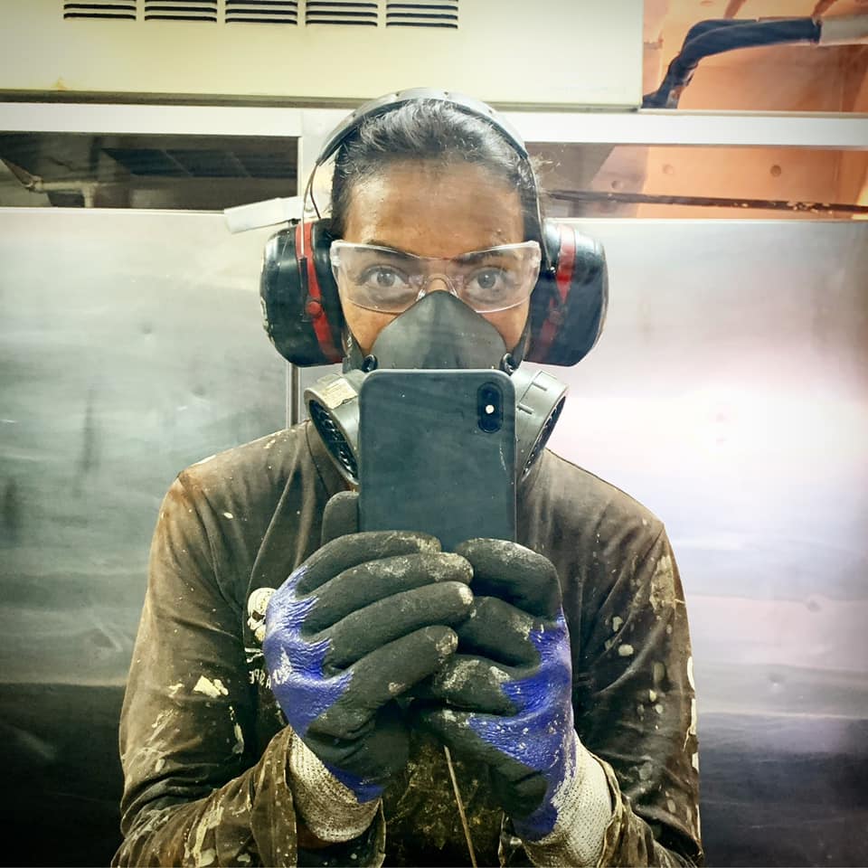 Nathalie Gil working on the Sea Shepherd ship, equipped with safety gear, actively contributing to marine conservation efforts.