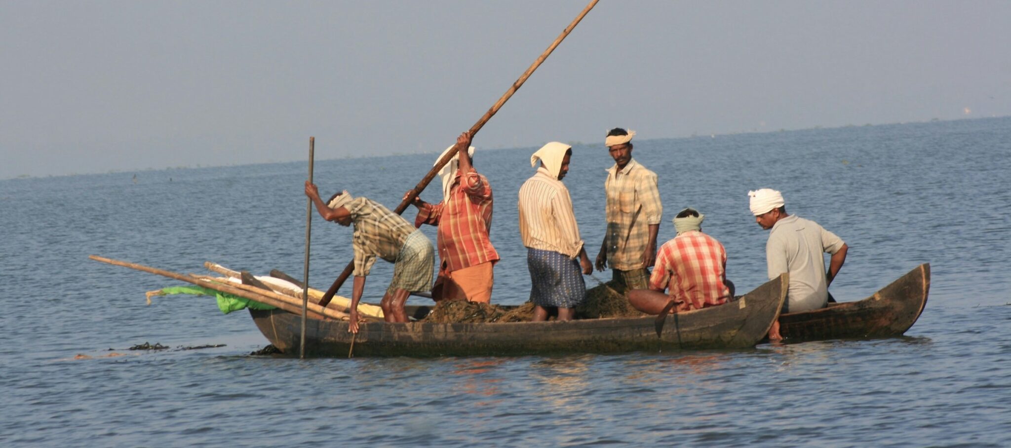 Fishermen in a traditional wooden boat on the water. Become an oceanographer and you could study physical, chemical and other processes that affect fisheries.