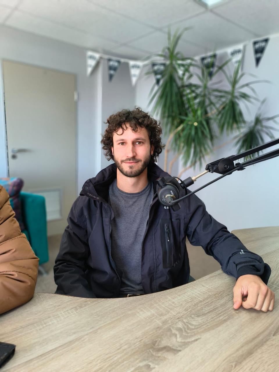 A conservationist being interviewed for a local radio talk discussing conservation efforts and the importance of community involvement in environmental protection.