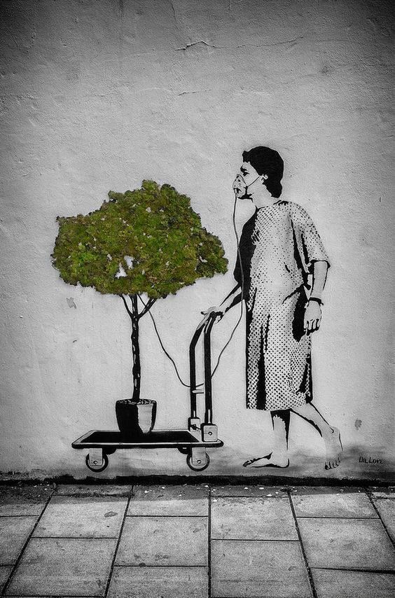 Street art by Dr. Love showing a patient in a hospital gown using an oxygen mask connected to a live potted tree on a trolley, symbolising the healing power of nature.