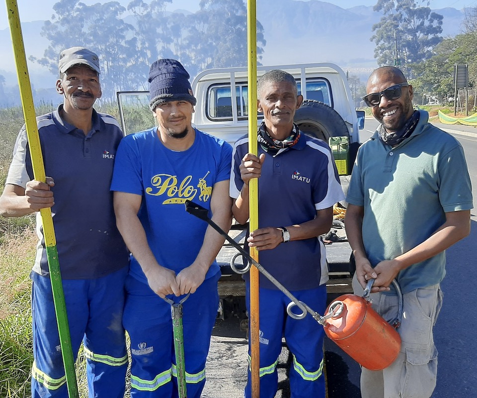 Four male nature conservationists smiling.