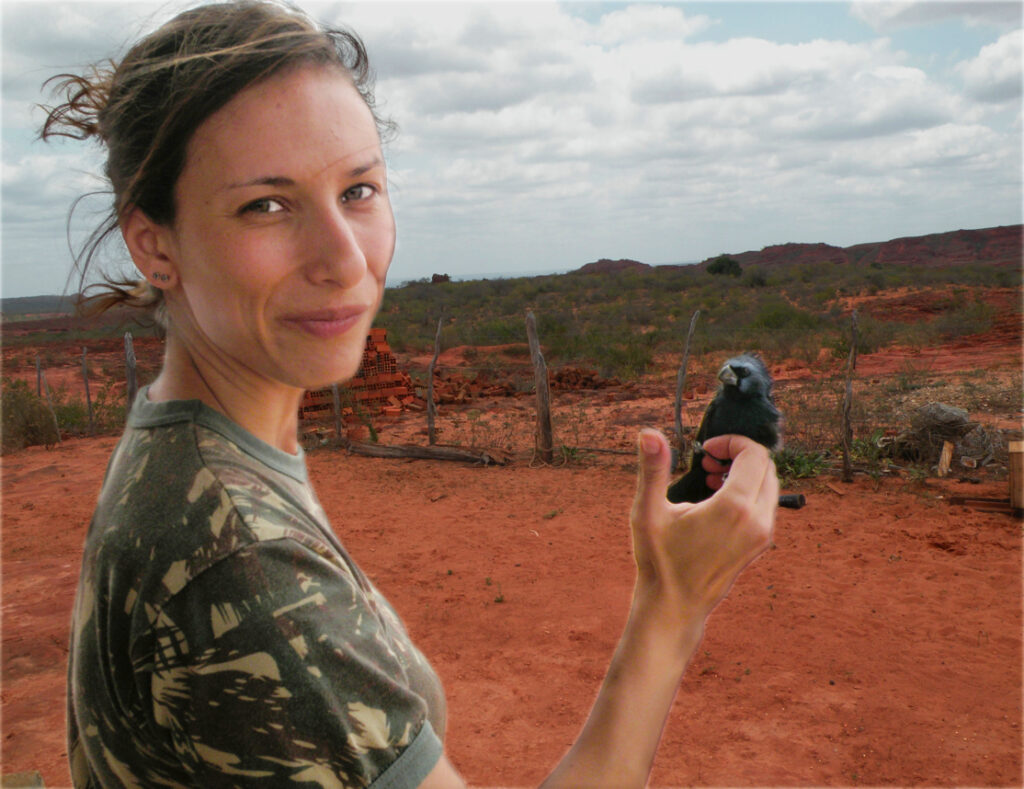 Juliana handling a bird during fieldwork.