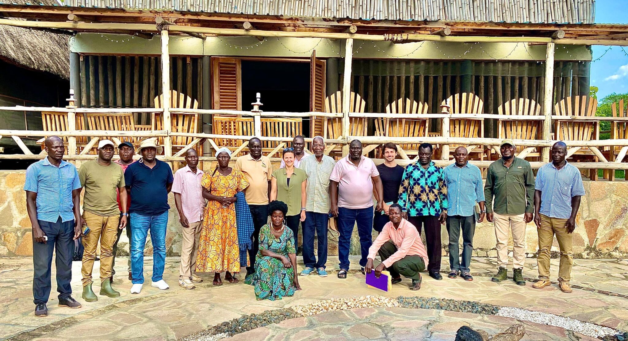 Matthew and project partners with local stakeholders during a field visit in Uganda, highlighting the importance of collaboration between communities, conservation practitioners, and development specialists.